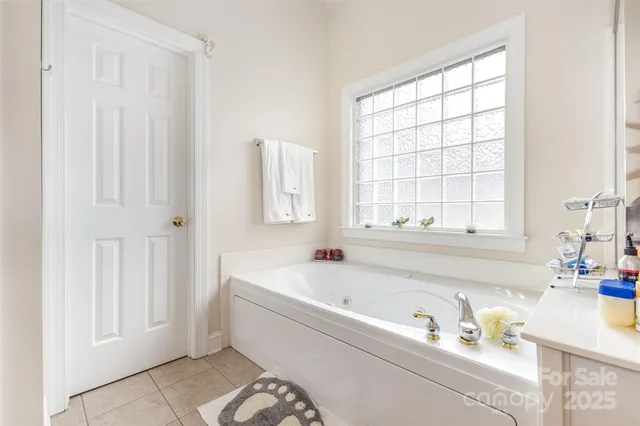 a white bath tub sitting next to a window