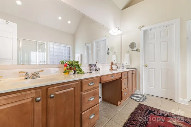 a spacious bathroom with a double vanity sink mirror and
