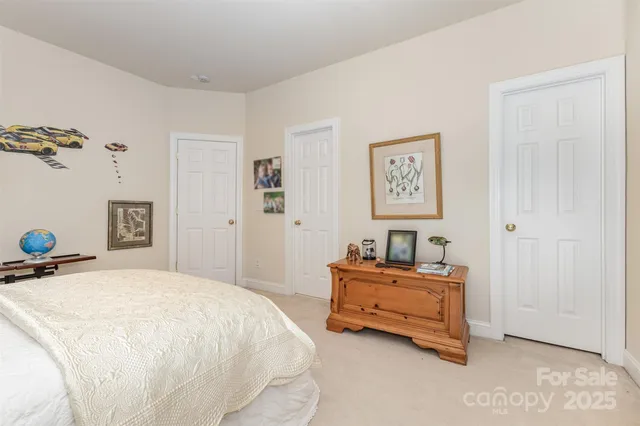 a spacious bedroom with a bed and a table in it