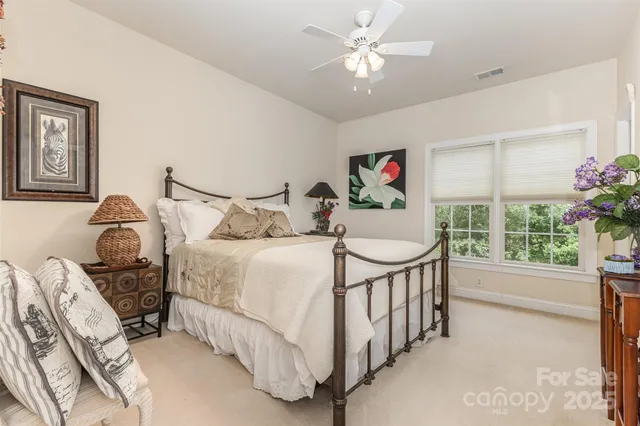 a bedroom with furniture and a chandelier
