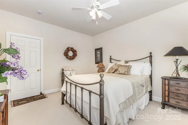 a bedroom with bed and a chandelier