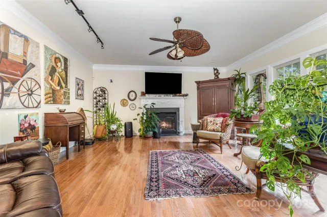 a living room with furniture fireplace and flat screen tv