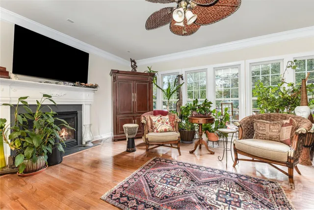 a living room with furniture fireplace and flat screen tv