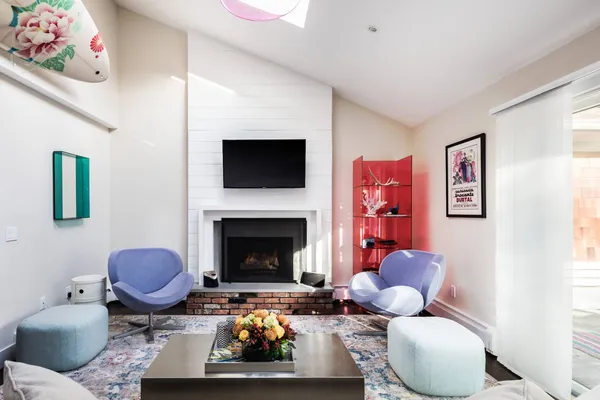 a living room with furniture a flat screen tv and a fireplace