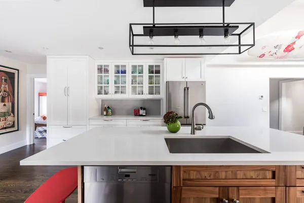 a kitchen with kitchen island a sink appliances and cabinets