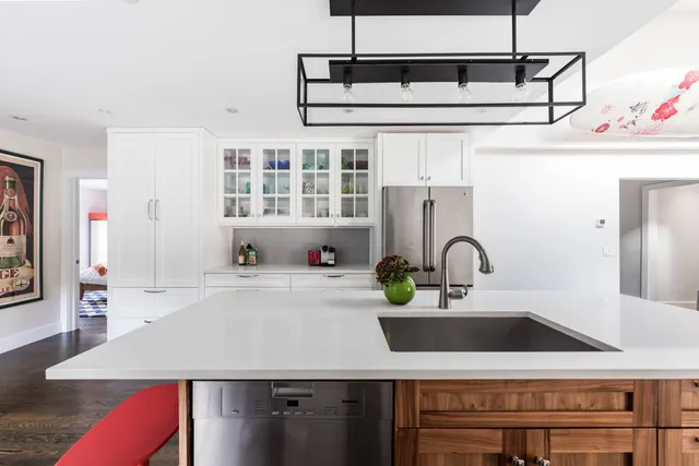 a kitchen with kitchen island a sink appliances and cabinets