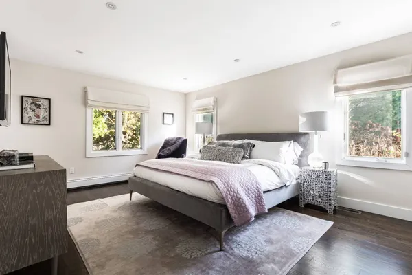 a spacious bedroom with a bed and a window