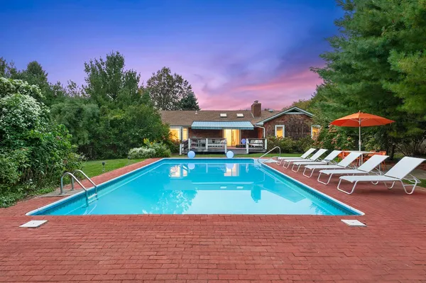 a house with swimming pool in front of it