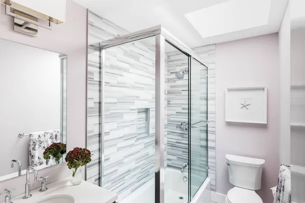 a bathroom with a toilet sink and shower