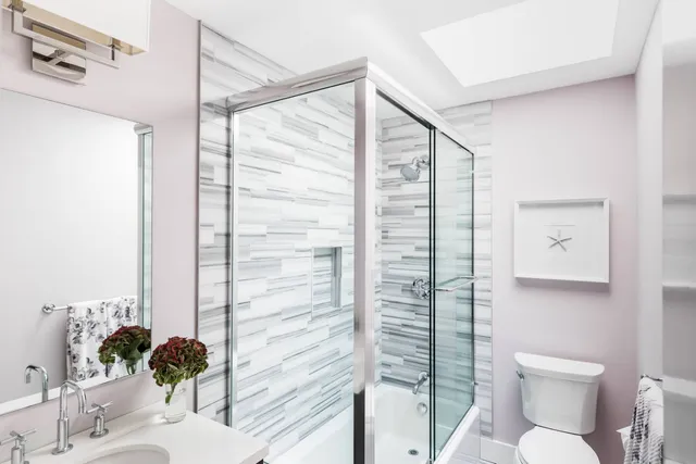 a bathroom with a toilet sink and shower