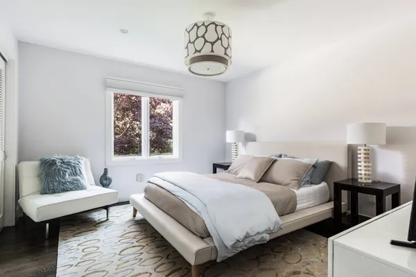 a bedroom with bed and a window