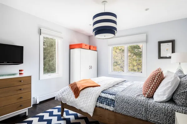 a bedroom with a bed and a flat screen tv