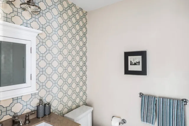 a bathroom with a toilet and a shower curtain