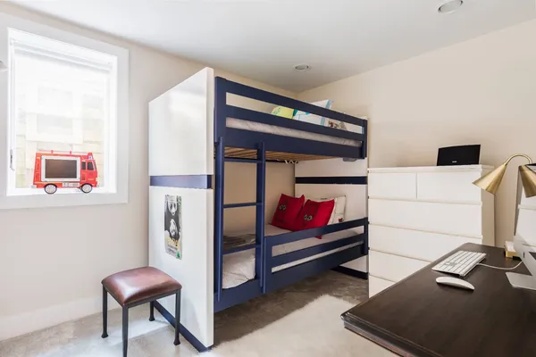 a bedroom with furniture and a chair