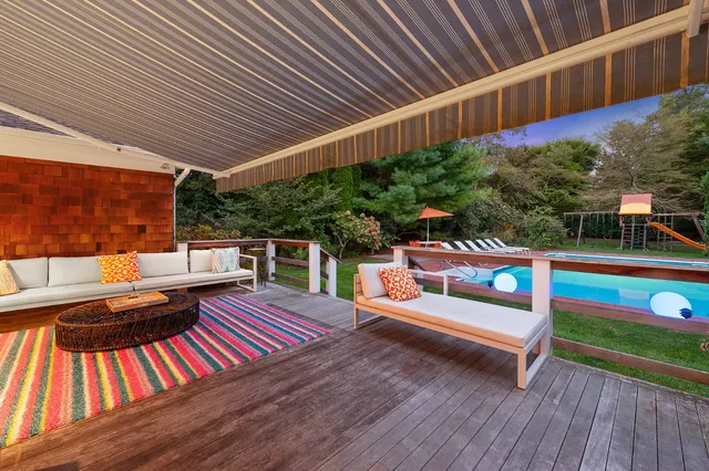 a view of outdoor sitting area with furniture and wooden deck