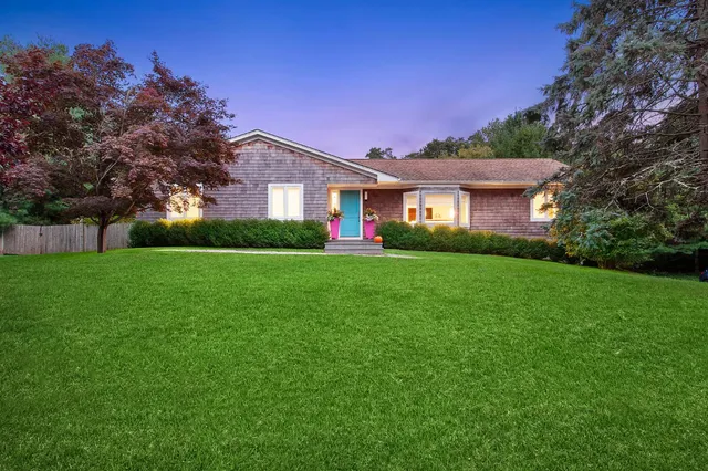 a front view of house with yard and green space