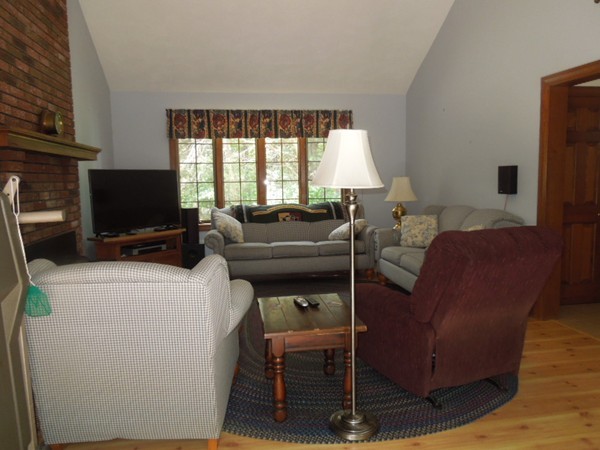 294 Rangeway Road Billerica, MA 01862 - Photo 4 of 28 a living room with furniture a flat screen tv and a window