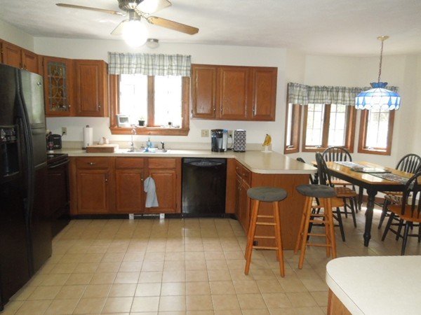 294 Rangeway Road Billerica, MA 01862 - Photo 6 of 28 a kitchen with a sink a counter top space appliances and cabinets
