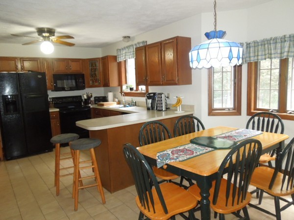 294 Rangeway Road Billerica, MA 01862 - Photo 7 of 28 a kitchen with a dining table chairs and refrigerator