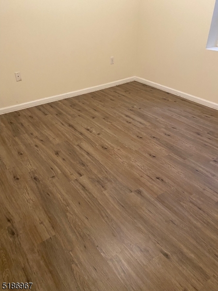 41 Wainwright Street Newark, NJ 07112 - Photo 2 of 7 an empty room with wooden floor