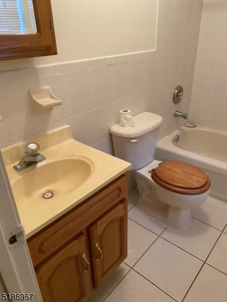 41 Wainwright Street Newark, NJ 07112 - Photo 5 of 7 a bathroom with a sink toilet and a mirror