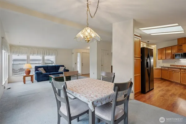 a view of a dining room with furniture and a chandelier