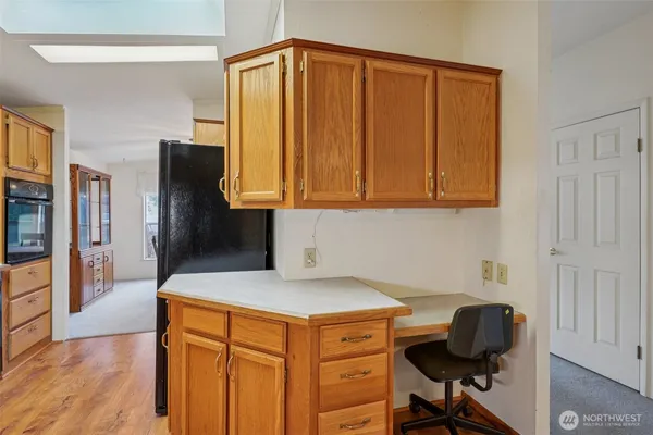a kitchen with stainless steel appliances granite countertop a sink refrigerator and cabinets