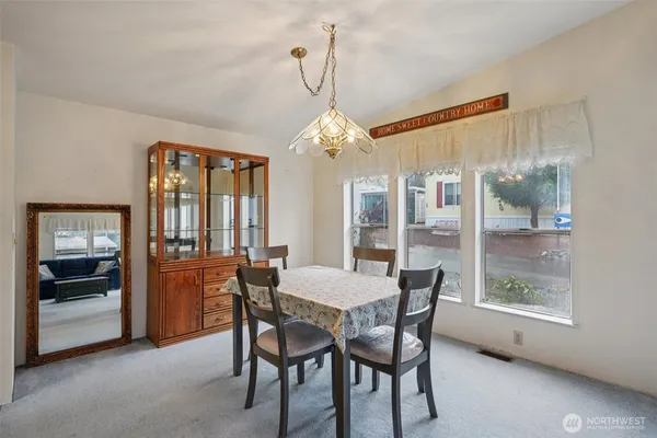 a dining room with furniture and window