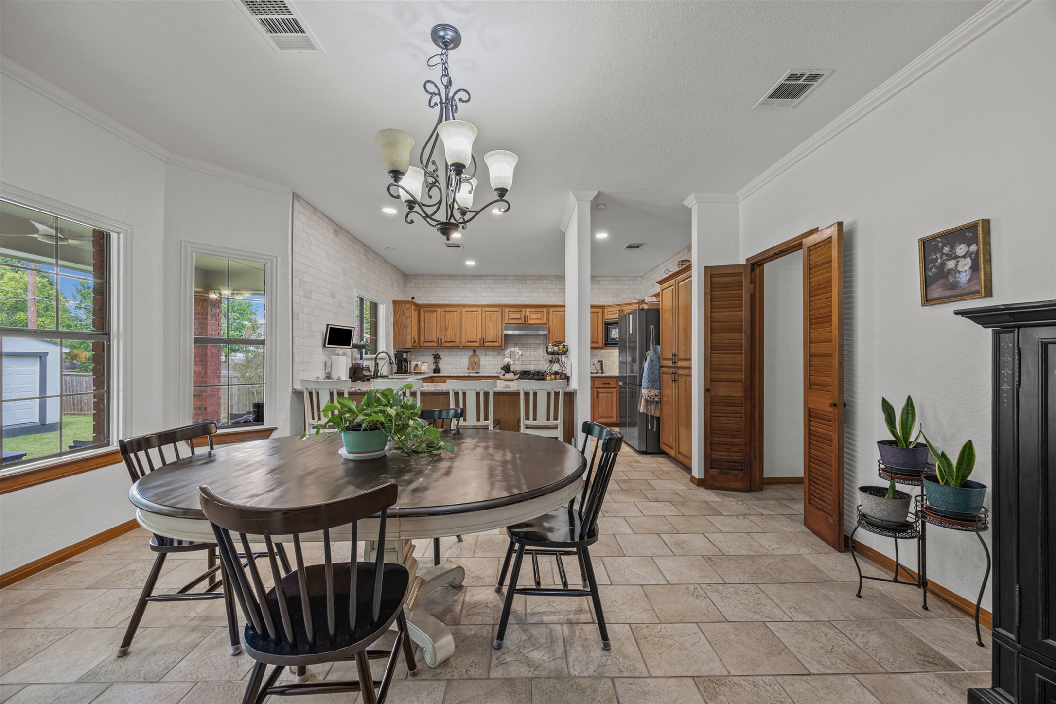 2000 Spinel Road Pflugerville, TX 78660 - Photo 6 of 31 An open-concept living space connects the well-appointed kitchen to a bright dining area with views of the outdoors.