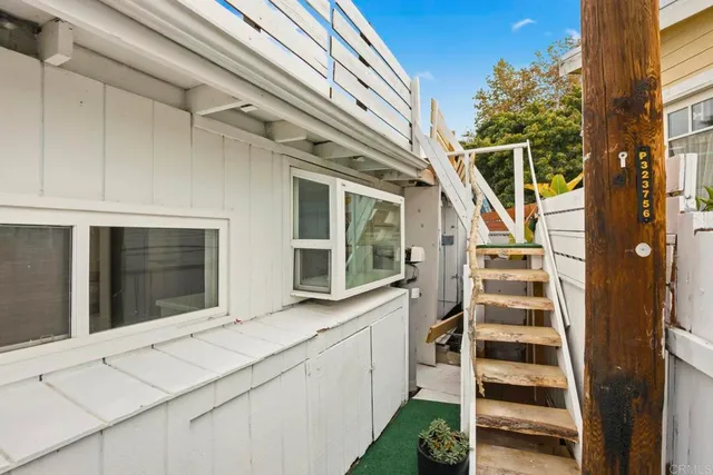 a view of a backyard with a garden and fire pit