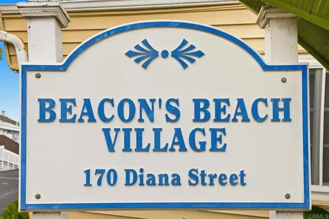 an aerial view of a city with ocean view in back