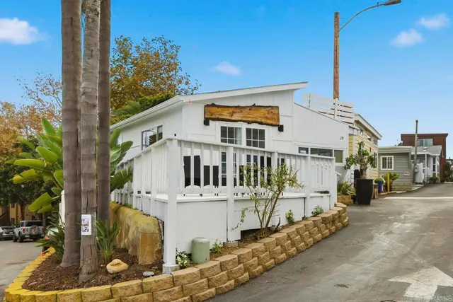 a view of a balcony with plants and palm tree