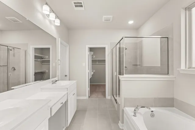 a bedroom with bed and a potted plant