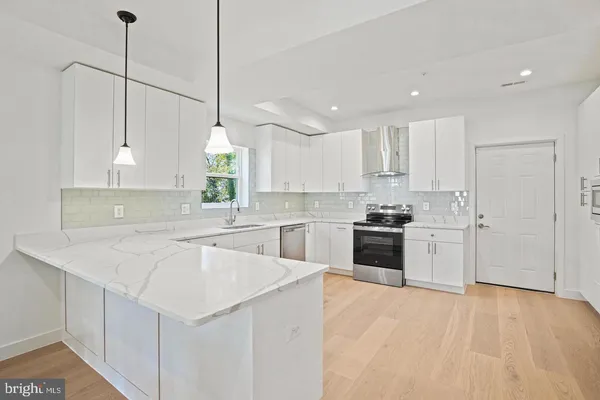 a kitchen with white cabinets and white appliances