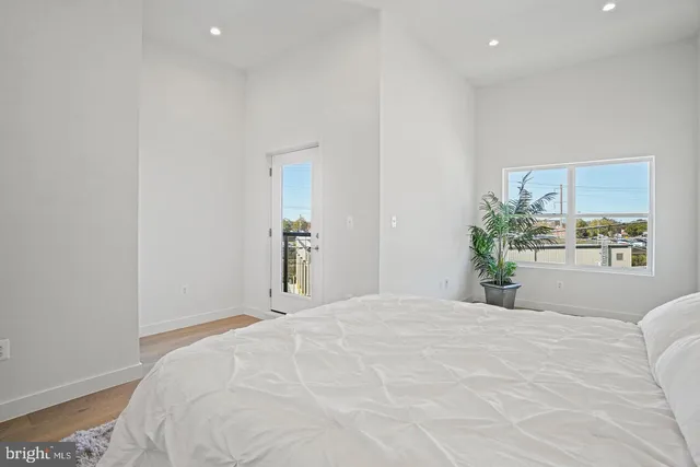 a bedroom with a large bed and a potted plant