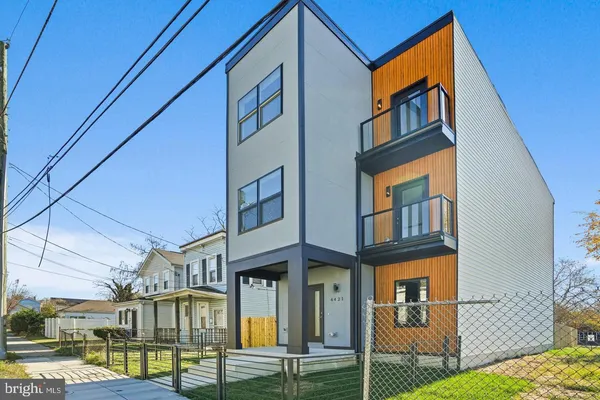 a front view of a residential apartment building with a yard