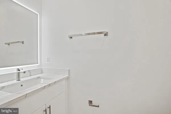 a bathroom with a sink and mirror