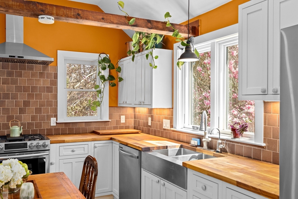 385 Whiting Street Hanover, MA 02339 - Photo 11 of 42 a view of a kitchen with a sink and a window