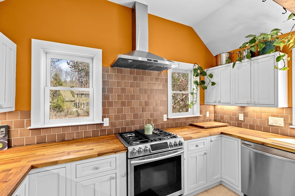 385 Whiting Street Hanover, MA 02339 - Photo 12 of 42 a kitchen with stainless steel appliances a stove a sink and a microwave