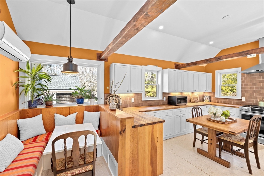 385 Whiting Street Hanover, MA 02339 - Photo 13 of 42 a very nice looking living room with a large window a dining table and chairs