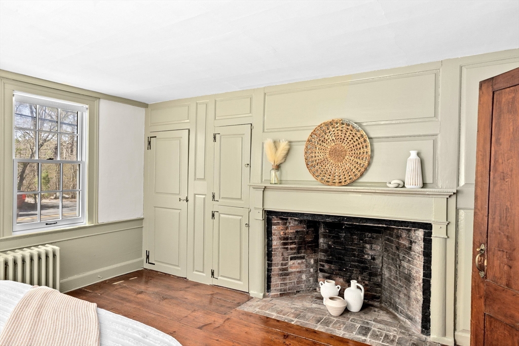 385 Whiting Street Hanover, MA 02339 - Photo 21 of 42 a view of a livingroom with wooden floor and a fireplace