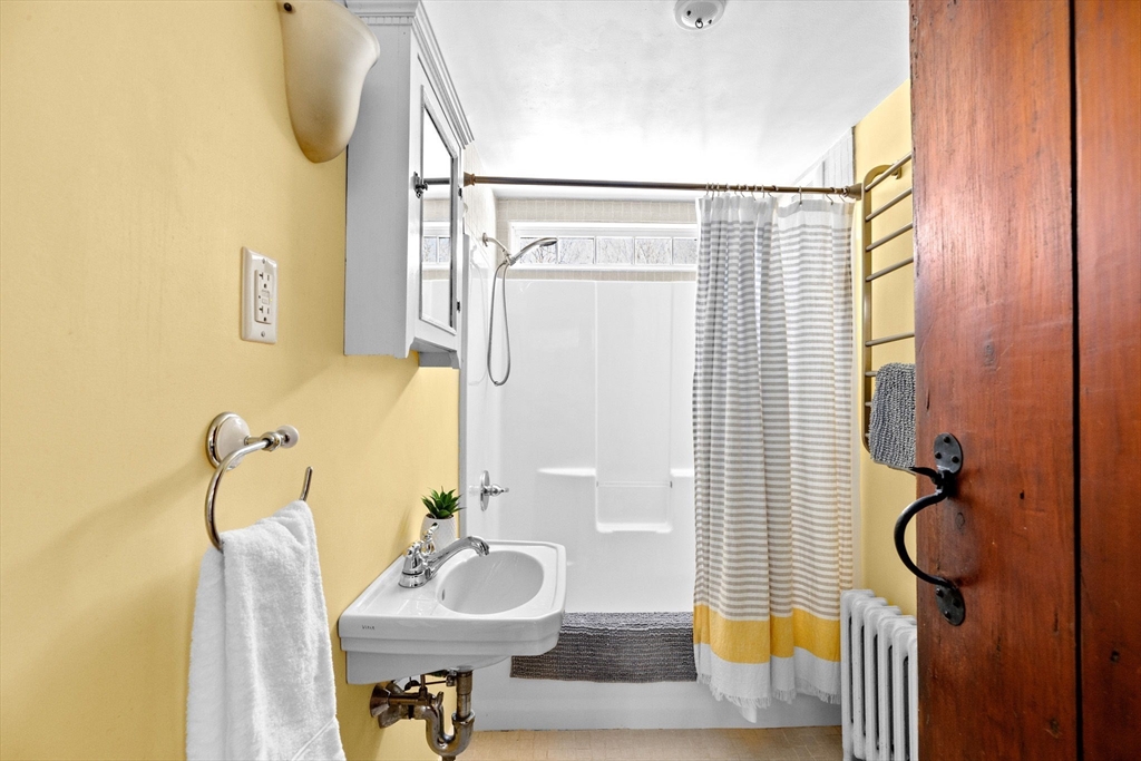 385 Whiting Street Hanover, MA 02339 - Photo 23 of 42 a bathroom with a sink and mirror