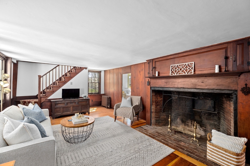 385 Whiting Street Hanover, MA 02339 - Photo 4 of 42 a living room with furniture and a fireplace