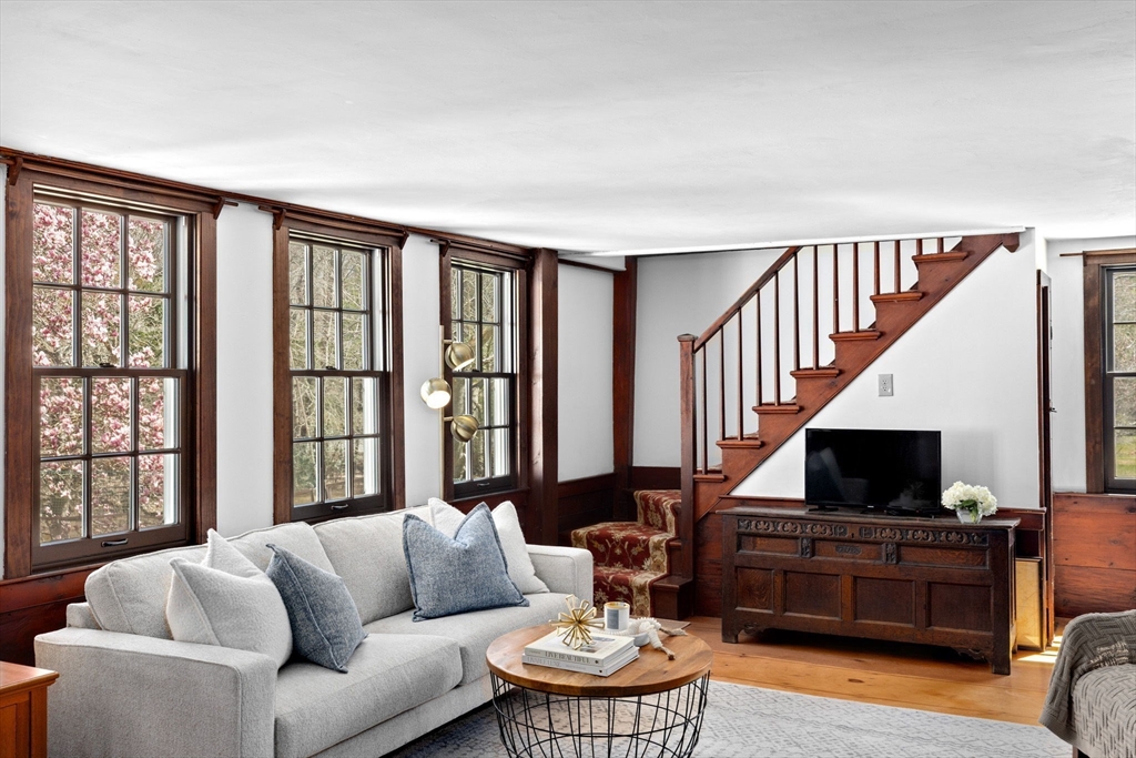 385 Whiting Street Hanover, MA 02339 - Photo 5 of 42 a living room with furniture fireplace and a flat screen tv