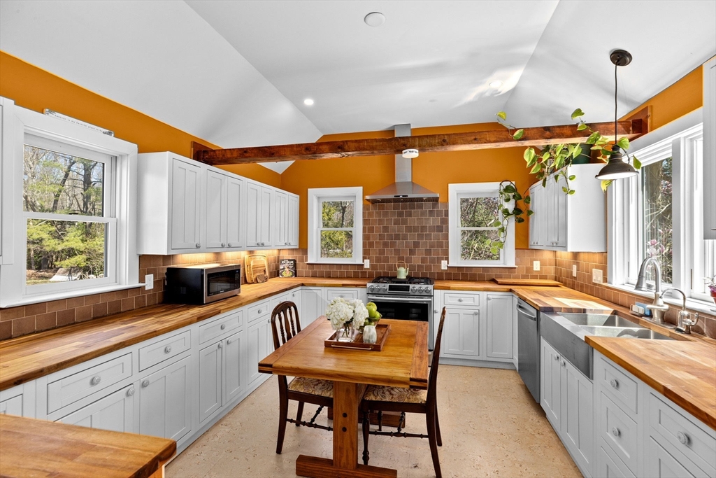 385 Whiting Street Hanover, MA 02339 - Photo 10 of 42 a large kitchen with a table and chairs