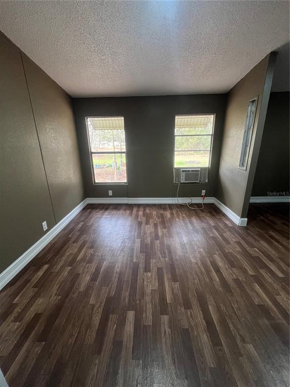 10330 Northeast 90th Street Bronson, FL 32621 - Photo 12 of 28 an empty room with wooden floor and windows
