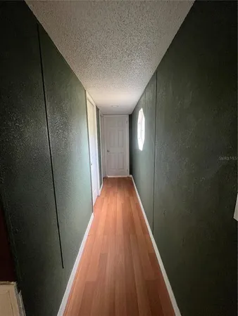 a view of room with window and wooden floor