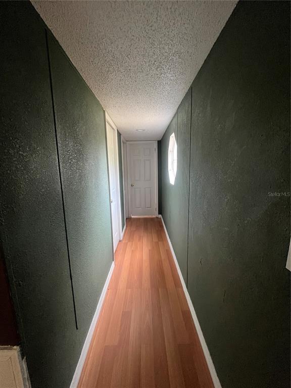 10330 Northeast 90th Street Bronson, FL 32621 - Photo 17 of 28 a view of hallway with wooden floor