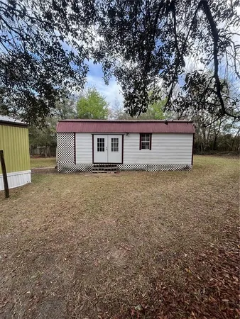 a view of a tiny house with a yard