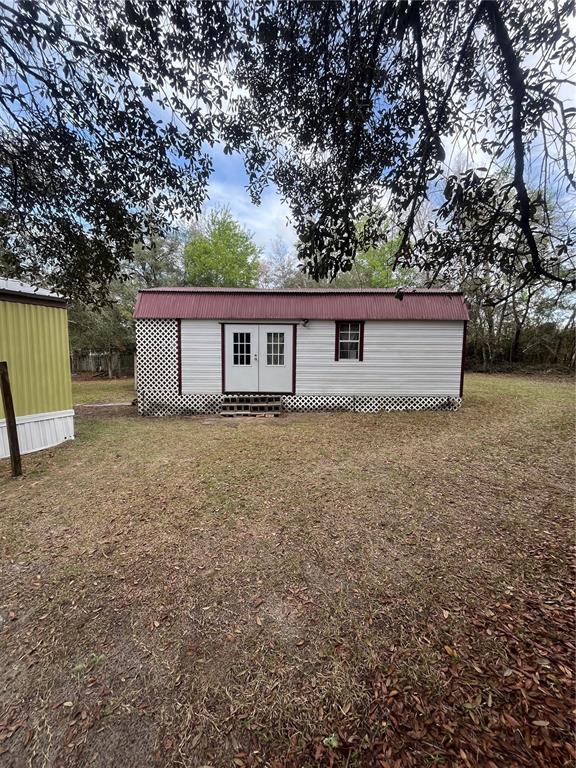 10330 Northeast 90th Street Bronson, FL 32621 - Photo 24 of 28 a house view with a garden space